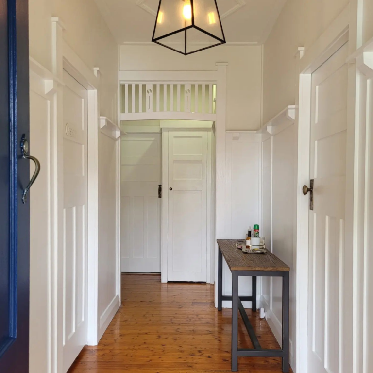 a hallway with a table and a light fixture