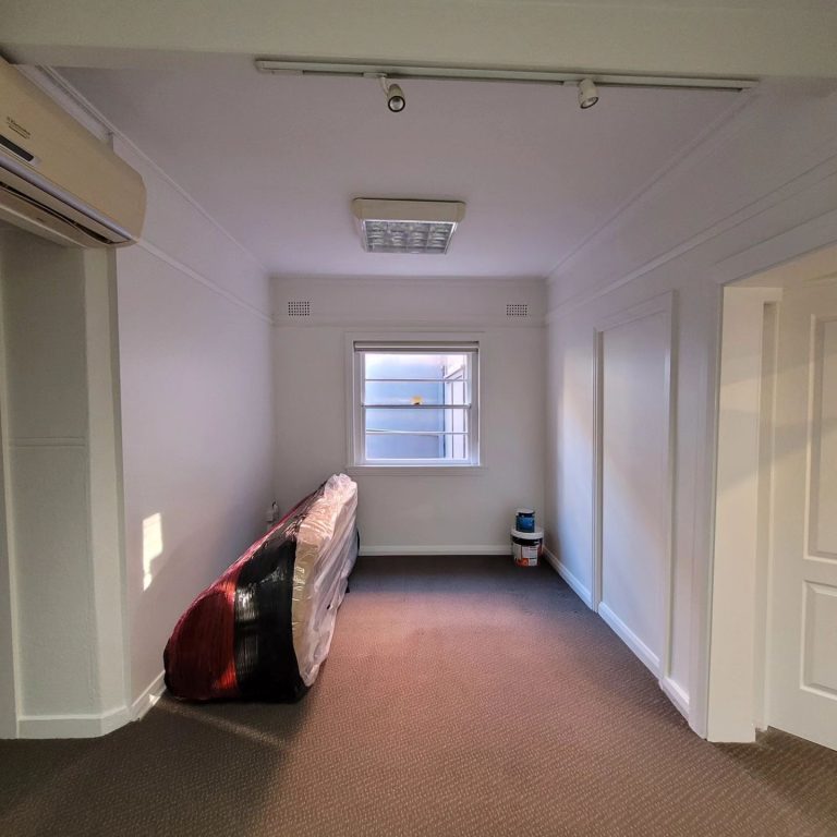 a room with a mattress and a window